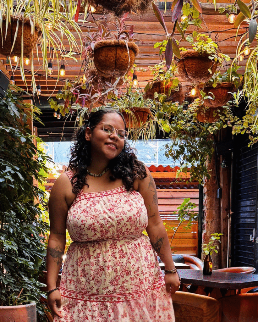 What makes a website good? 1 a woman standing in a restaurant surrounded by plants