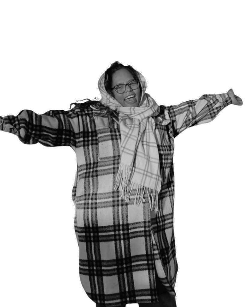 Website Portfolio 1 Judith - a wearing a plaid coat and a scarf with her arms out